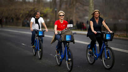 Women enjoy a warm day on their bikes in Central Park