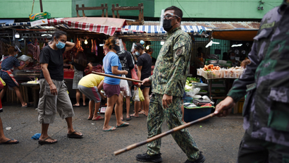Police patrol a market in the Philippines