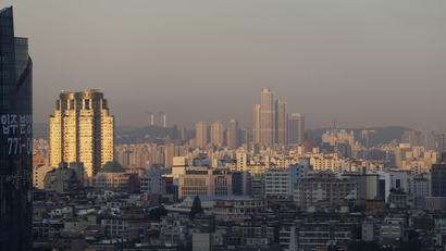 Several tall buildings and a dense array of shorter ones are seen in a city skyline of Seoul