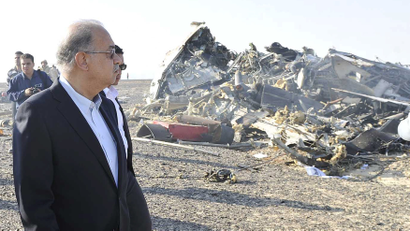 Egypt's Prime Minister Sherif Ismail looks at the remains of a Russian airliner after it crashed in central Sinai near El Arish city, north Egypt, October 31, 2015. The Airbus A321, operated by Russian airline Kogalymavia under the brand name Metrojet, carrying 224 passengers crashed into a mountainous area of Egypt's Sinai peninsula on Saturday shortly after losing radar contact near cruising altitude, killing all aboard.
