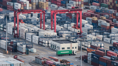 A cargo truck drives amid stacked shipping containers at the Yangshan port in Shanghai, Thursday, March 29, 2018. China's Commerce Ministry called on Washington on Thursday to discard planned tariffs it warned might set off a chain reaction that could disrupt global trade and said Beijing will "fight to the end". (AP Photo)