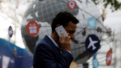 A delegate speaks on the phone as he attends the National Association of Software and Services Companies (NASSCOM) India Leadership Forum in Mumbai