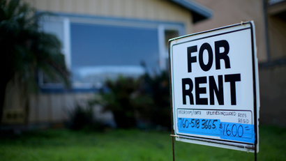 a 'for rent' sign sits in the front yard of a one-story house