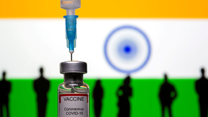 3D-printed small toy figurines, a syringe and vial labelled "coronavirus disease (COVID-19) vaccine" are seen in front of India flag in this illustration