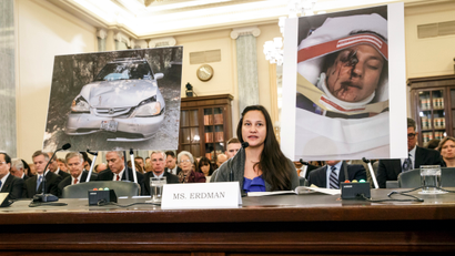 Stephanie Erdman, an Air Force 1st lieutenant, describes her experience when she was injured by metal fragments from a defective airbag made by Takata of Japan, as she testifies on Capitol Hill in Washington, Thursday, Nov. 20, 2014, before the Senate Commerce Committee hearing on the devices linked to multiple deaths and injuries in cars driven in the US. Hiroshi Shimizu, senior vice president of global quality assurance at Takata, waits to testify at far left.