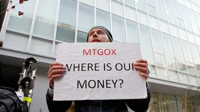 Kolin Burges, a self-styled cryptocurrency trader and former software engineer who came from London, holds a placard to protest against Mt. Gox, in front of the building where the digital marketplace operator is housed in Tokyo February 25, 2014. The website of Mt. Gox appears to be taken down, shortly after six major Bitcoin exchanges released a joint statement distancing themselves from the troubled Tokyo-based bitcoin exchange. Tokyo-based Mt. Gox was a founding member and one of the three elected industry representatives on the board of the Bitcoin Foundation.