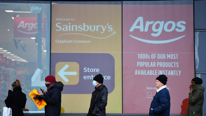 People queue for a supermarket, as the spread of the coronavirus disease (COVID-19) continues, in London, Britain, March 20, 2020.