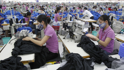 Labourers work at a garment factory owned by Singaporeans outside Hanoi October 19, 2012.