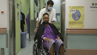 A hospital staff pushes Ken Tsang Kin-chiu on a wheelchair for a medical examination at Ruttonjee Hospital in Hong Kong