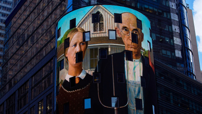 A reproduction of the art work "American Gothic" is displayed on a digital billboard in Times Square,