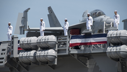 A handout photo made available by the US Navy shows Sailors manning the rails of the aircraft carrier USS Gerald R. Ford (CVN 78) during its commissioning ceremony at Naval Station Norfolk, Virginia, USA, 22 July 2017. Ford is the lead ship of the Ford-class aircraft carriers, and the first new US aircraft carrier designed in 40 years. US President Donald J. Trump (not pictured) presided over the commissioning.
