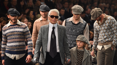 German designer Karl Lagerfeld (C) walks the runway at the end of the 12th Chanel Metiers dArt show 'Paris-Rome', an annual event to honor craftsmanship that artisan partners bring to the houses collections, on December 1, 2015 at the Cinecitta studios in Rome.