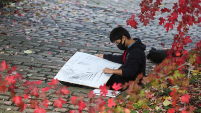 First year architecture student Shuntaro Moyiyama from Japan draws during his first contact with the Newcastle University since he joins over a week ago at Quayside in Newcastle, Britain October 14, 2020. REUTERS/Lee Smith