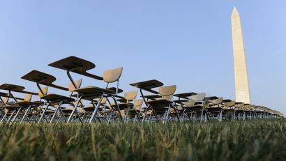 An art installation of 857 empty school desks stands at the National Mall, near the Washington Monument, in Washington June 20, 2012. Each of the desks represents a U.S. student who drops out every hour of every school day, according to the College Board which set up the installation. A team of local college students, supporting the "Don't Forget Ed" national movement, collected signatures on site for a petition to be sent to U.S. presidential candidates asking them to prioritize education in the presidential campaign.