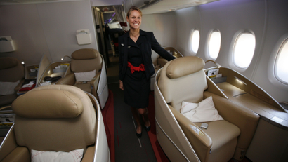 An Air France KLM flight attendant poses at the first class cabin of new Airbus A380 aircraft during a hand-over ceremony at the manufacturer's site in Finkenwerder near Hamburg October 30, 2009. Air France has taken delivery of its first Airbus A380 on Friday as the first European airline to fly the double-deck aircraft on scheduled services. REUTERS/Christian Charisius