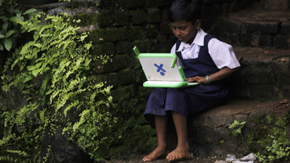 A school girl uses a laptop provided under the "One Laptop Per Child' project by a non-governmental organisation (NGO), in a state-run primary school in Khairat