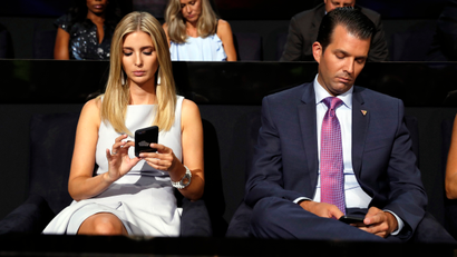 Republican Presidential Candidate Donald Trump's children Ivanka Trump and Donald Trump Jr., check on their phones during the second day session of the Republican National Convention in Cleveland, Tuesday, July 19, 2016.