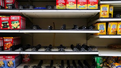 Sparse supermarket shelves in the cracker aisle.