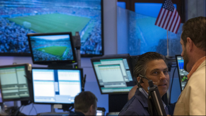 Screens show the 2014 World Cup soccer match between U.S. and Germany as traders work on the floor of the New York Stock Exchange