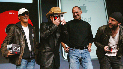 October 26, 2004U2 lead singer Bono jokes as he stands with Apple CEO Steve Jobs and U2 guitarist The Edge during a news conference in San Jose.