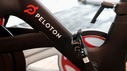 the pedals and frame of a Peloton exercise bike are seen