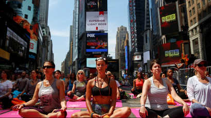 People doing Yoga in Times Square.