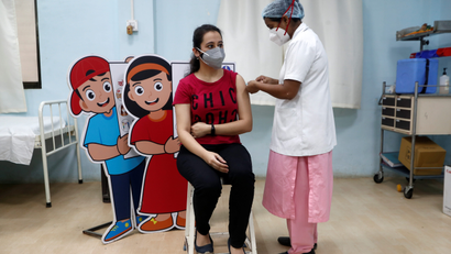 Woman receives a vaccine in Mumbai, India