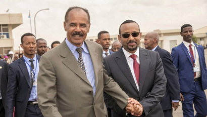 Eritrean President Isaias Afwerki and Ethiopia's Prime Minister Abiy Ahmed and walk together at Asmara International Airport, Eritrea July 9, 2018 in this photo obtained from social media on July 10, 2018.
