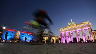 The Brandenburg Gate and the U.S. embassy are illuminated during a rehearsal for the upcoming Festival of Lights in Berlin