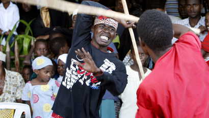 Two men perform the traditional Swahili dance Kirumbizi-Kirumbizi in Lamu, Kenya.