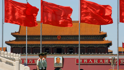 Paramilitary solders stand guard at Tiananmen Square where the portrait of late Chinese chairman Mao Zedong is seen, on the 50th anniversary of the start of the Cultural Revolution in Beijing