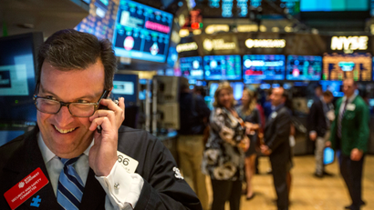 A trader works on the floor of the New York Stock Exchange shortly before the end of the day's trading in New York July 31, 2013.
