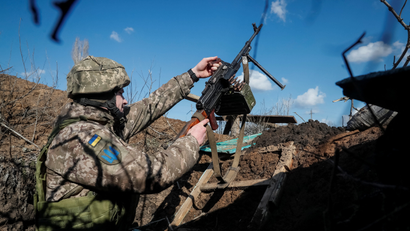 A Ukrainian soldier in a trench on the front line near the village of Travneve, in the Donetsk region of Ukraine.