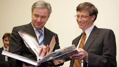 Berlin mayor Klaus Wowereit, left, and Microsoft founder Bill Gates, right, take a look at book about Berlin after Gates signed the Golden guest book of the City of Berlin in the Red City Hall in Berlin on Tuesday, Jan. 22, 2008. (AP Photo/Miguel Villagran)
