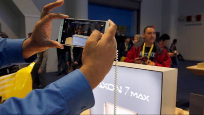 A man takes a photo with an Axon 7 Max smartphone with 3D camera at the ZTE booth during the 2017 CES in Las Vegas, Nevada January 6, 2017