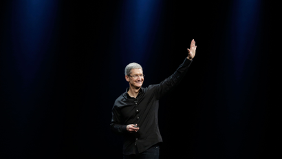 Apple CEO Tim Cook waves while walking off stage after the keynote address of the Apple Worldwide Developers Conference Monday, June 10, 2013 in San Francisco. (AP Photo/Eric Risberg)