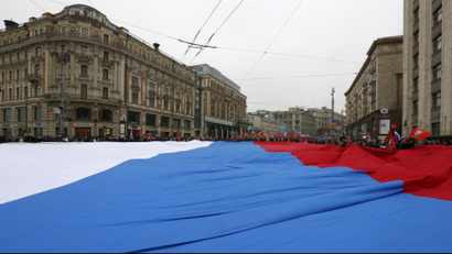 Participants march with a giant Russian national flag during a demonstration during the 2015 National Unity Day in Moscow.