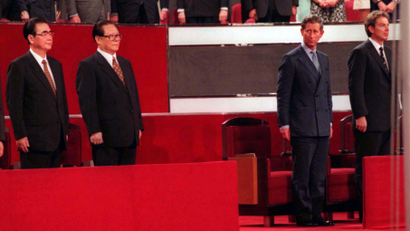 Chinese Foreign Minister Qian Qichen (L), Premier Li Peng (2nd-L), President Jiang Zemin (3rd-L), Britain's Prince Charles (2nd-R) and Prime Minister Tony Blair (R) stand to attention between the flag poles following the Chinese national flag raising at the handover ceremony in Hong Kong July 1.