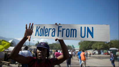 FILE PHOTO - A protester holds up a sign during a demonstration against the UN mission in downtown Port-au-Prince November 18, 2010. Reuters/Allison Shelley/File Photo
