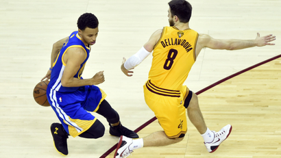 Jun 11, 2015; Cleveland, OH, USA; Golden State Warriors guard Stephen Curry (30) controls the ball against Cleveland Cavaliers guard Matthew Dellavedova (8) during the first quarter of game four of the NBA Finals at Quicken Loans Arena.