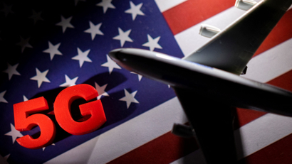 An illustration of an airplane soaring in front of an American flag with "5G" emblazoned on it.