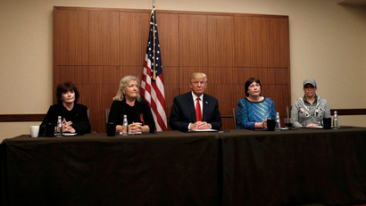 Republican presidential nominee Donald Trump sits with (from R-L) Paula Jones, Kathy Shelton, Juanita Broaddrick and Kathleen Willey in a hotel conference room in St. Louis, Missouri, U.S., shortly before the second presidential debate at Washington University in St. Louis, October 9, 2016. REUTERS/Mike Segar - RTSRICY
