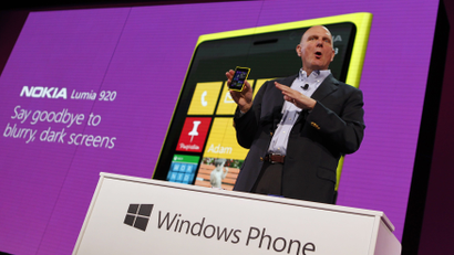 Microsoft CEO Ballmer displays a Nokia Lumia 920 featuring Windows Phone 8 during an event in San Francisco