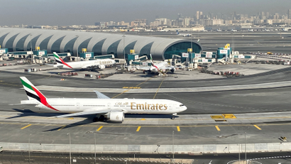 An image of an airplane belonging to Emirates airline at an airport