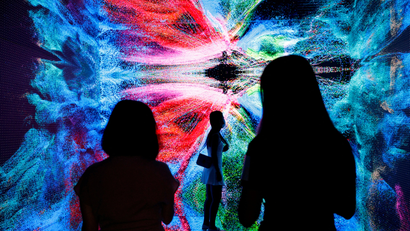 FILE PHOTO: Visitors are pictured in front of an immersive art installation titled "Machine Hallucinations - Space: Metaverse" by media artist Refik Anadol at the Digital Art Fair, in Hong Kong