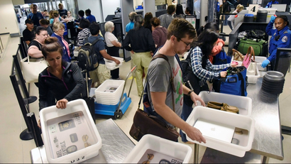 Travelers going through a TSA screening