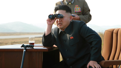 North Korean leader Kim Jong Un looks through a pair of binoculars as he guides a flight drill for the inspection of airmen of the Korean People's Army (KPA) Air and Anti-Air Force in this undated photo released by North Korea's Korean Central News Agency (KCNA) in Pyongyang October 30, 2014.