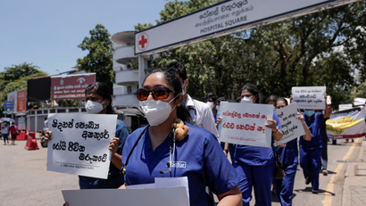 Government Medical Officers' Association members walk with placards protesting against Sri Lankan President Gotabaya Rajapaksa after his government lost its majority in parliament during a demonstration near the parliament building in Colombo, Sri Lanka, April 6, 2022.