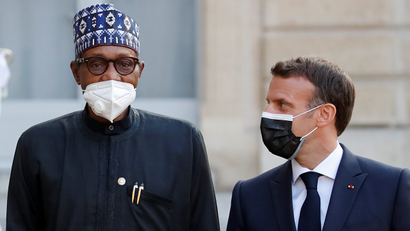 French President Emmanuel Macron welcomes Nigerian President Muhammadu Buhari for a dinner with leaders of African states and international organisations on the eve of a summit on aid for Africa, at Elysee Palace in Paris on May 17.