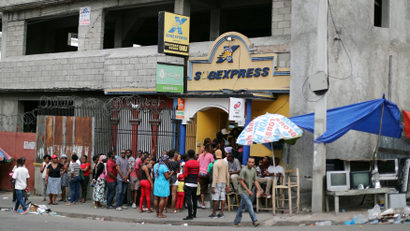 People line up outside a money transfer point at a neighborhood in Port-au-Prince, Haiti, February 16, 2019.